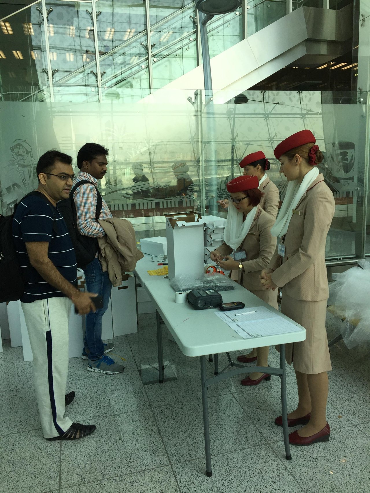 Emirate staff packing laptops.jpg